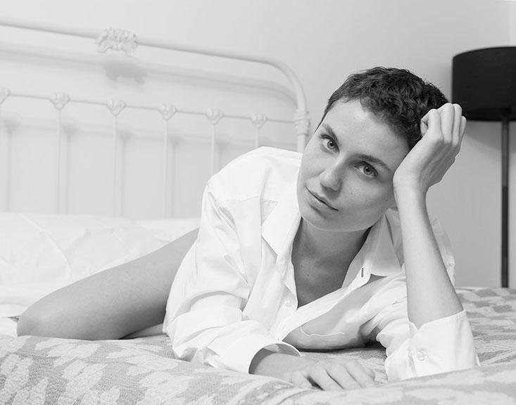 Lifestyle-photography-on-bed-with-white-button-down-shirt-New-York-Fashion-Photographer
